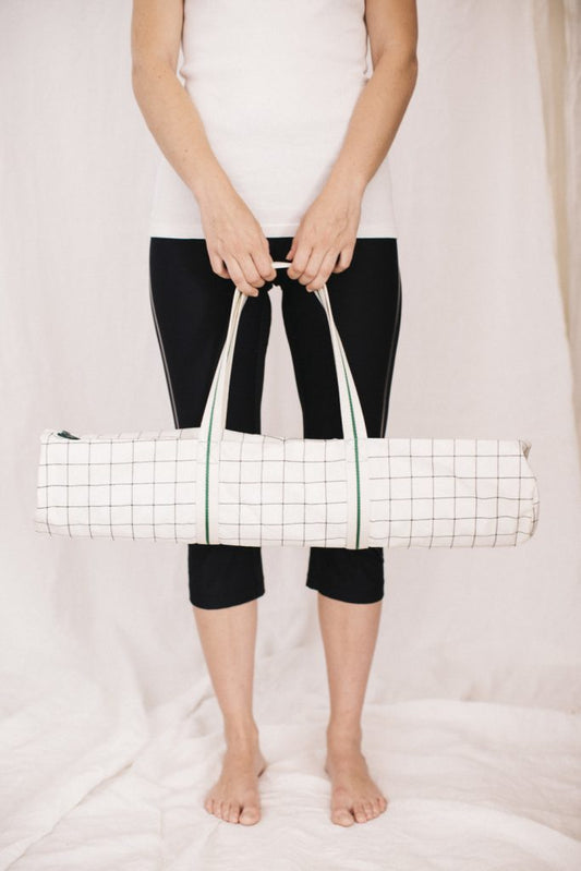 White yoga mat bag with black and green stripes