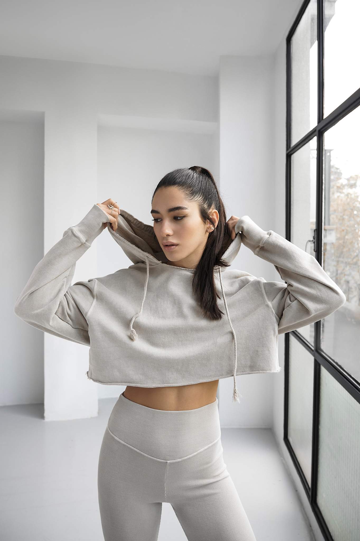 Made in Barcelona · 100 % Premium Organic Cotton · Made to Last · Environmental Friendly Dye · Extremely soft fabric · Brushed finish on the inside for a warm, smooth feeling · Easy-to-Wear and Match · Loose/Oversized fit · Raw cut on waist · Low shoulder · Oversized sleeves · Thumbholes · Worn-out feel · Light Beige - Front Image 